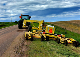 tractor mowing ditches