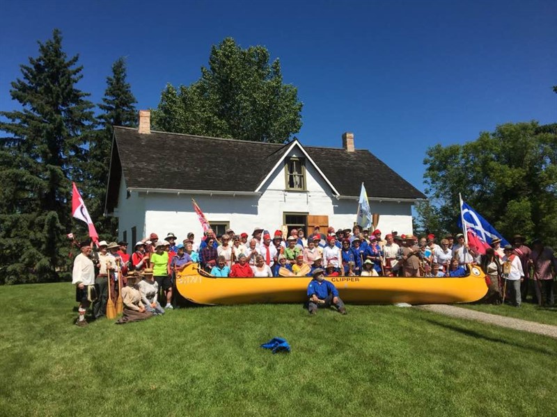 group of people behind a canoe